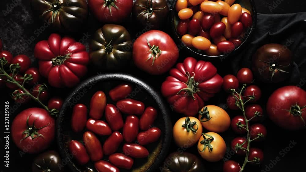 Various kinds of tomatoes placed on dark rusty table Various kinds of tomatoes placed on dark rusty table