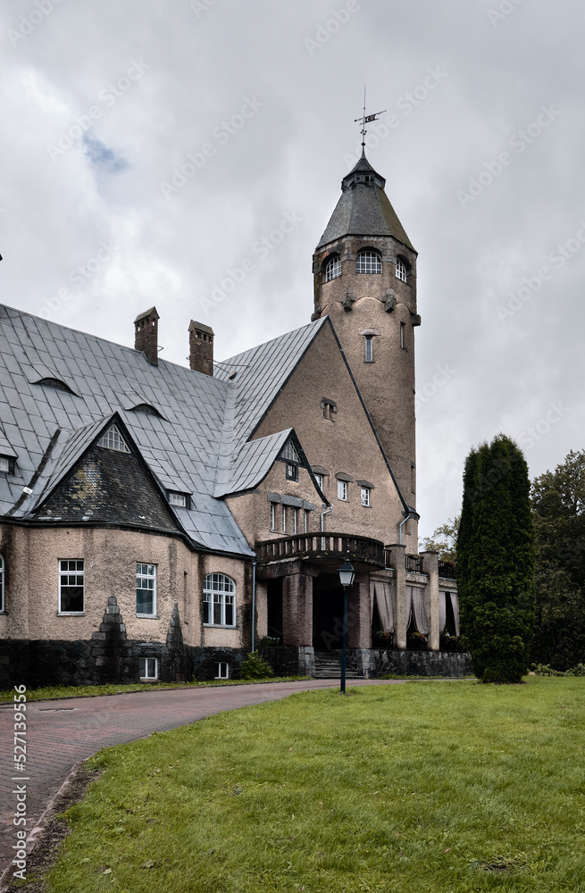 Taagepera castle in Taagepera village that is Helme Parish, Valga, Estonia. Main mansion and tower under grey overcast sky.