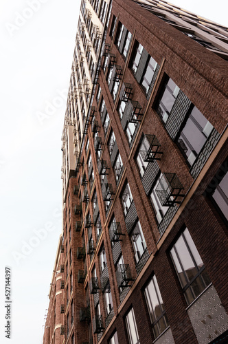 Residential building in the residential complex Now - Nagatinsky zaton - Technopark metro - Moscow - Russia. Dark red brick, grilles and tiles
