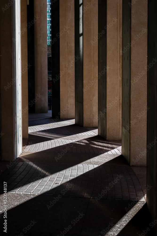 rays of light beam through a building's columns rays of light beam through a building's columns