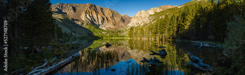 Reflection of mountains and trees on Parker Lake in California eastern sierra mountains 