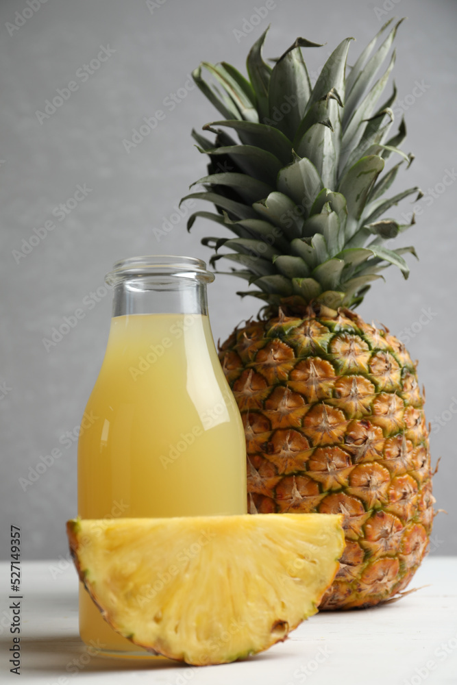 Delicious pineapple juice and fresh fruit on white wooden table Delicious pineapple juice and fresh fruit on white wooden table