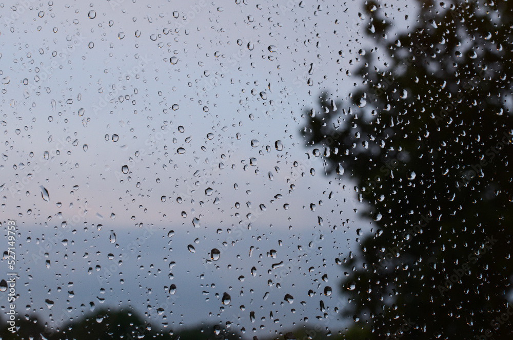 Window glass with water drops, closeup. Rainy weather Window glass with water drops, closeup. Rainy weather