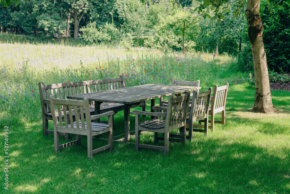 Empty wooden table with bench and chairs on sunny day outdoors Empty wooden table with bench and chairs on sunny day outdoors