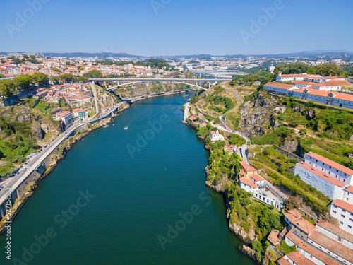 A scenic view of Porto and the Douro River with two bridges: Infante Dom Henrique and D. Maria Pia