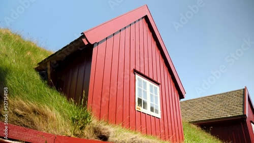 Parliament buildings in Tinganes, Torshavn, Faroe Islands. Grass rooftop with a window in a red buidling. Grass covered house. Typical scandinavian architecture in Torshavn. High quality 4k footage