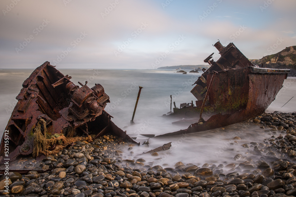 old stranded boat falling apart with the constant waves