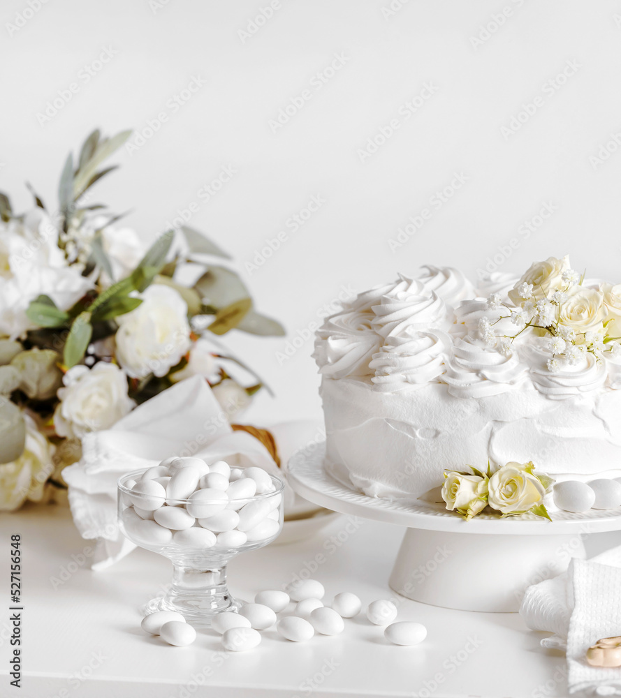Wedding cake with roses againsta white background, with copy space Wedding cake with roses againsta white background, with copy space