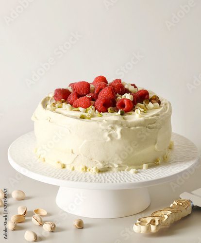Pistachio and raspberry cake with white frosting icing photo