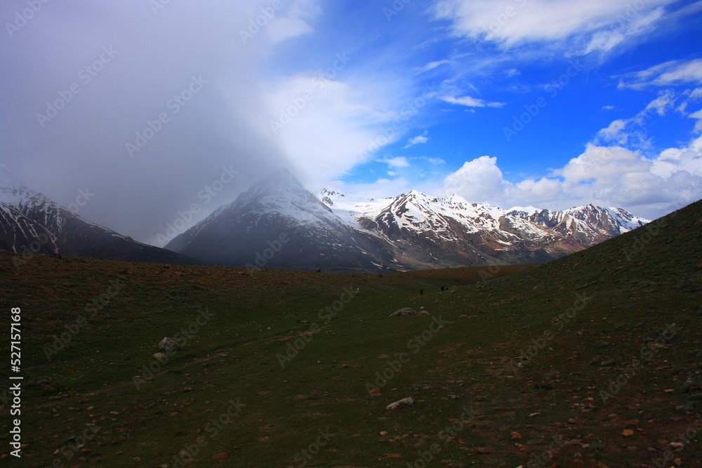 once-in-a-lifetime storm to see, clouds cuddling with the hills of Baroghil valley, Gilgit Baltistan, Pakistan. 