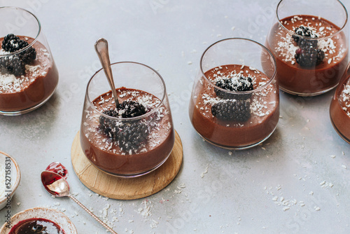 Chocolate blackberry mousse pots with desiccated coconut photo