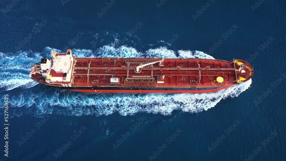 Aerial top down view of a 182 meters long oil chemical tanker ship. Supertanker loaded with full of oil, ploughs through the water. A petroleum tanker underway open sea
