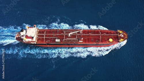 Aerial top down view of a 182 meters long oil chemical tanker ship. Supertanker loaded with full of oil, ploughs through the water. A petroleum tanker underway open sea
