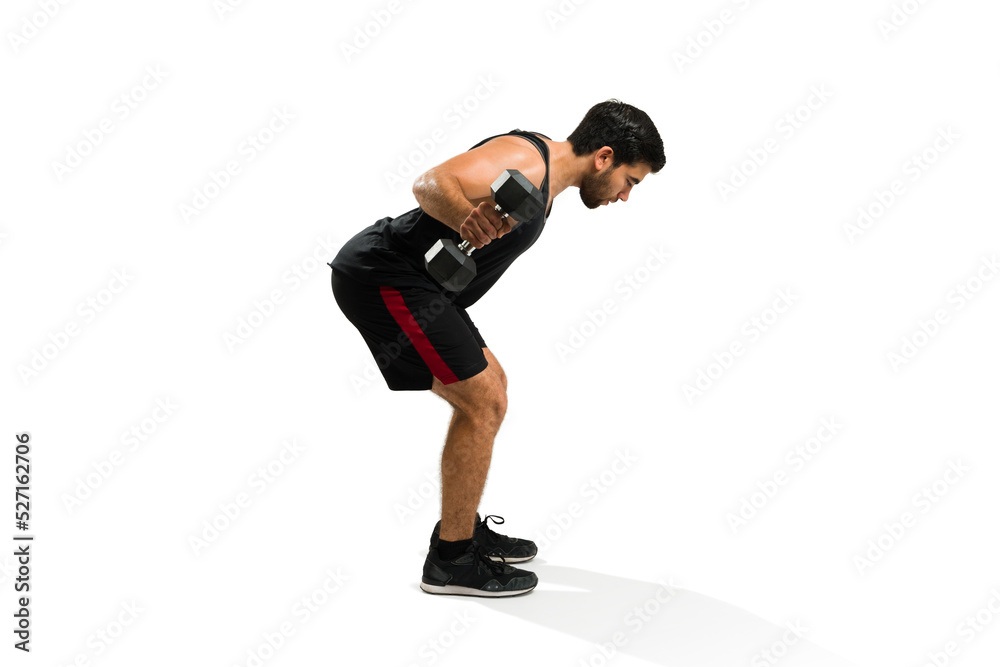 Active latin man working out doing dumbbell row exercises Active latin man working out doing dumbbell row exercises