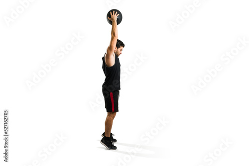 Active sporty man about to throw a slam ball to the floor using his strength © AntonioDiaz