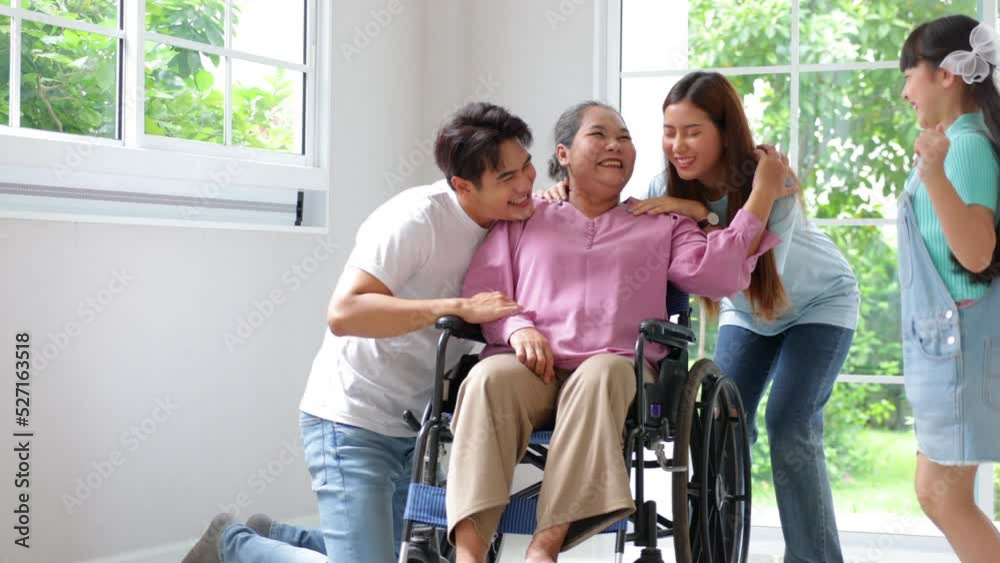 Happy asian family father, mother and daughter take good care of grandmother, They are smiling and laughing together at new house on moving day. Happy asian family father, mother and daughter take good care of grandmother, They are smiling and laughing together at new house on moving day.