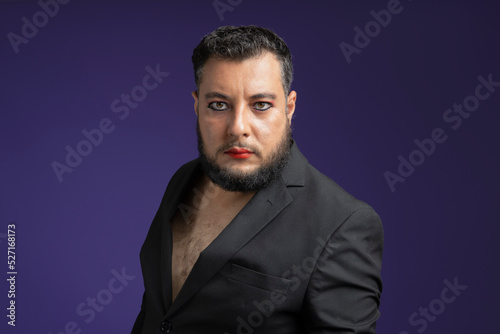medium shot of non binary person looking forward with dominant attitude on isolated purple background