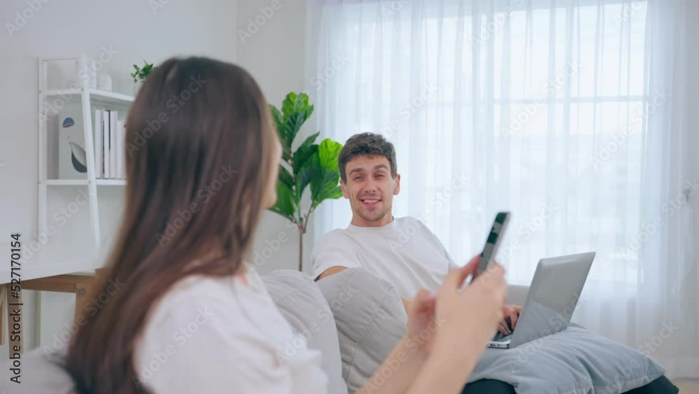 Caucasian young couple use laptop mobile phone in living room at home. Caucasian young couple use laptop mobile phone in living room at home.