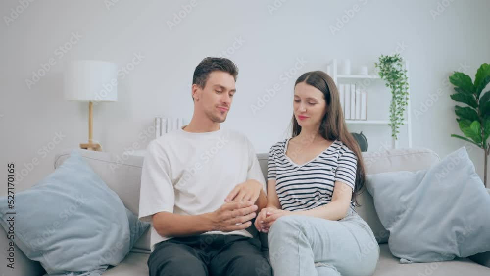 Portrait of Caucasian couple sitting on sofa in living room at home.
Portrait of Caucasian couple sitting on sofa in living room at home.