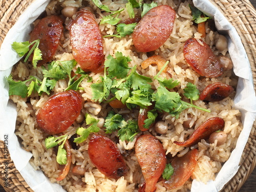 Top view fried rice with Chinese roasted dried pork sausage topped with fresh coriander