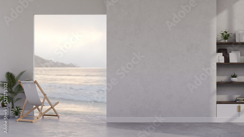 Modern white contemporary beach house interior with beach chair, balcony through the ocean