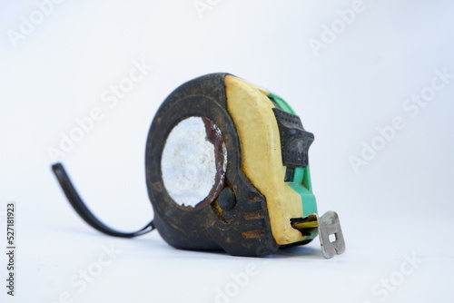 a used black, yellow, and green measuring tape isolated on white background, dirty measuring tape