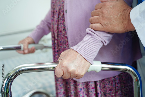 Doctor help Asian elderly woman disability patient in nursing hospital, medical concept.