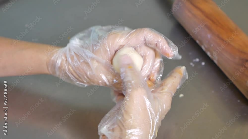Hand With Glove Wrap White Chinese Pastry Dough on Mug Bean Paste Filling, Close Up