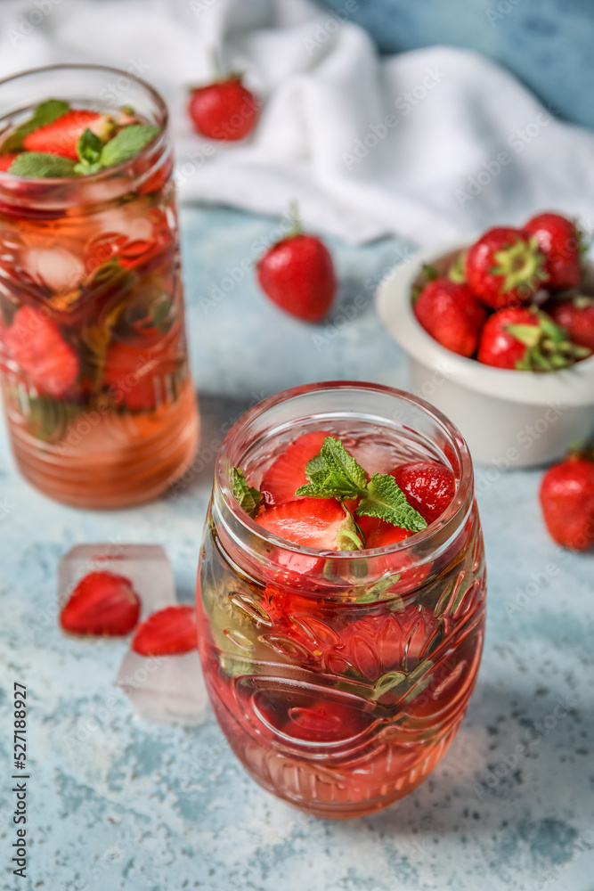 Glass of strawberry lemonade on blue background, closeup Glass of strawberry lemonade on blue background, closeup