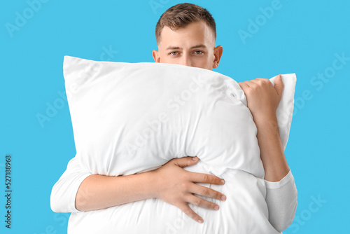 Young man with pillow on bl...