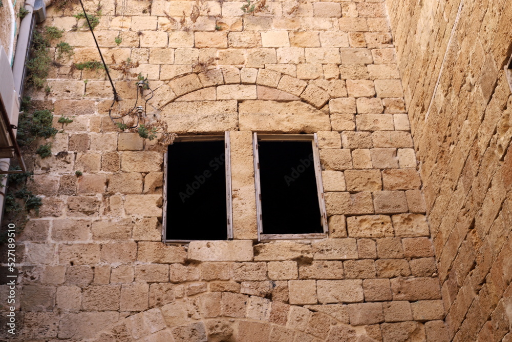 A small window on the facade of a large residential building.