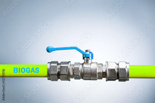 Biogas pipe, biogas plant. green tube and valve for biogas on grey background with copy space.