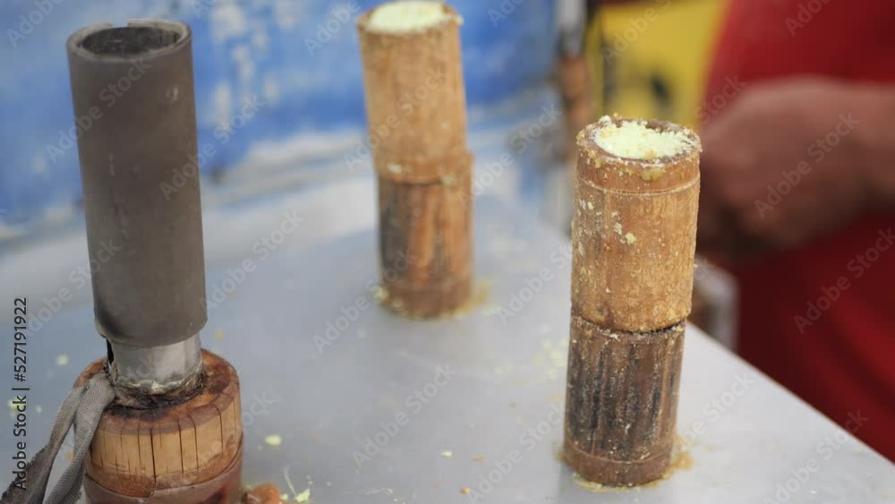 Process of making traditional indonesian food stall, kue putu bambu. From rice flour and formed using bamboo molds. the whistle sound of cooking and pandan aroma is very signature. Process of making traditional indonesian food stall, kue putu bambu. From rice flour and formed using bamboo molds. the whistle sound of cooking and pandan aroma is very signature.