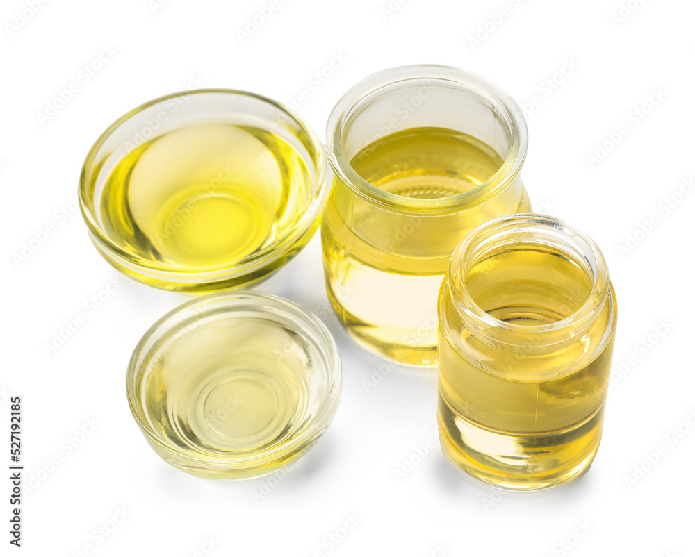 Glass bottles and bowls of sunflower oil on white background Glass bottles and bowls of sunflower oil on white background