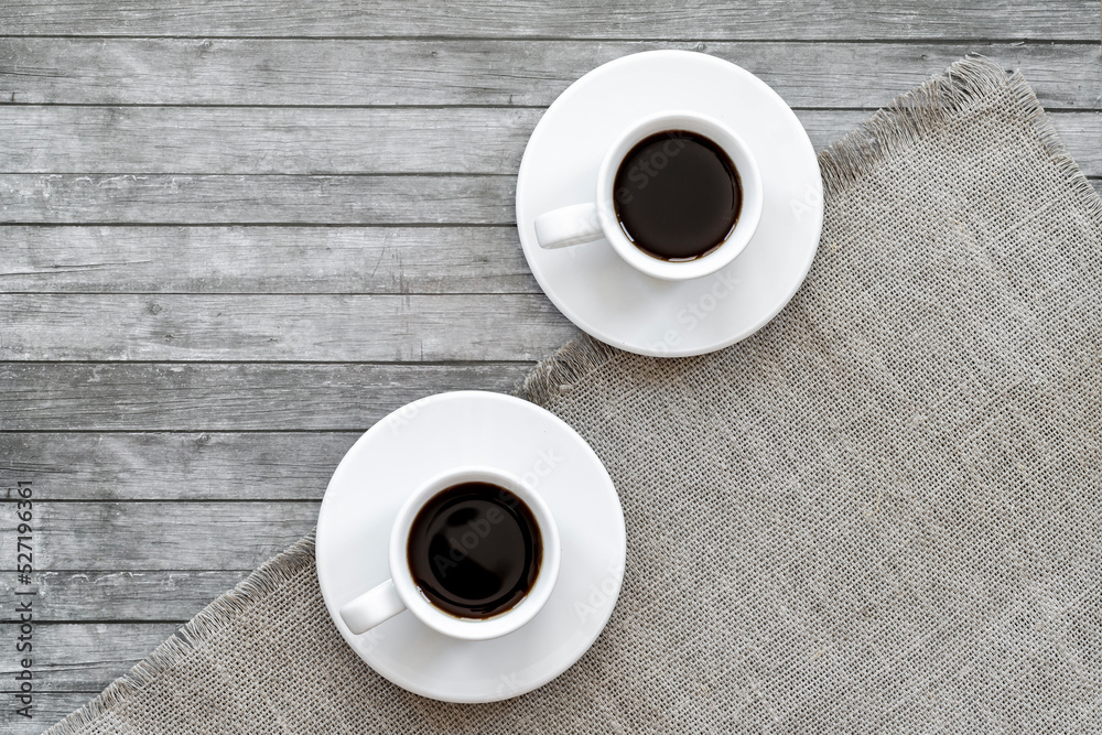 two white cups of black coffee on a gray surface, top view, flatley two white cups of black coffee on a gray surface, top view, flatley