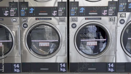 Washing machines with dirty laundry, public coin laundry, Self-service laundromat, laundrette.