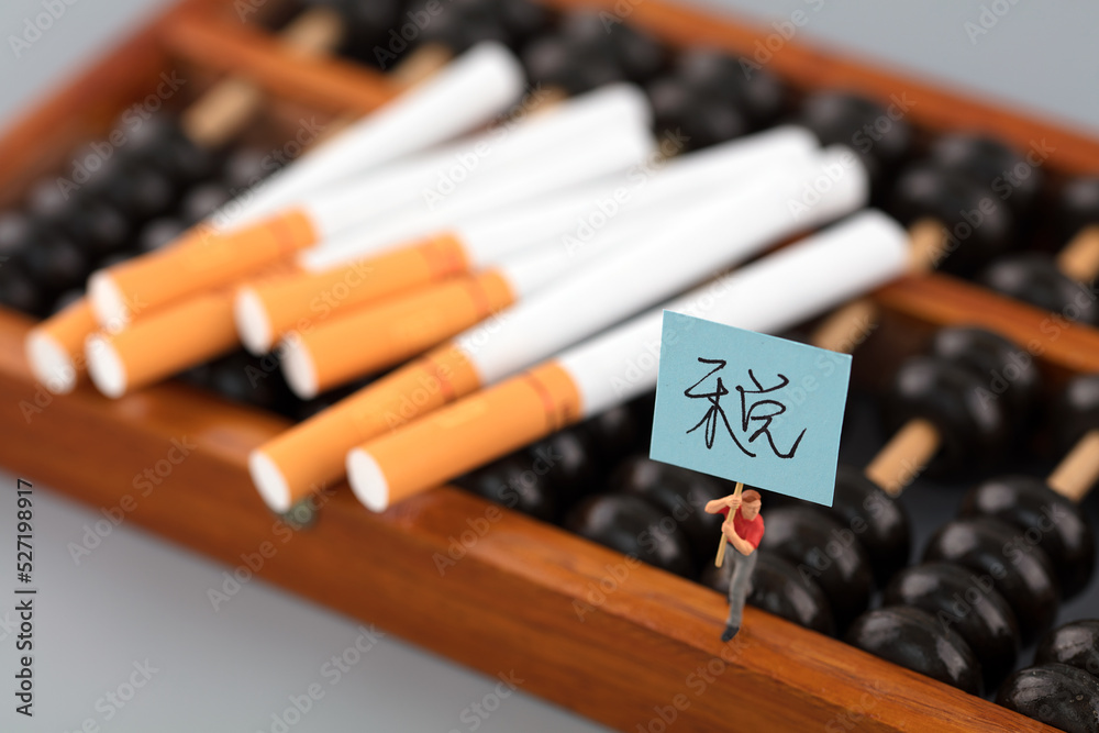 Miniature creative cigarettes hold taxes high on abacus Miniature creative cigarettes hold taxes high on abacus