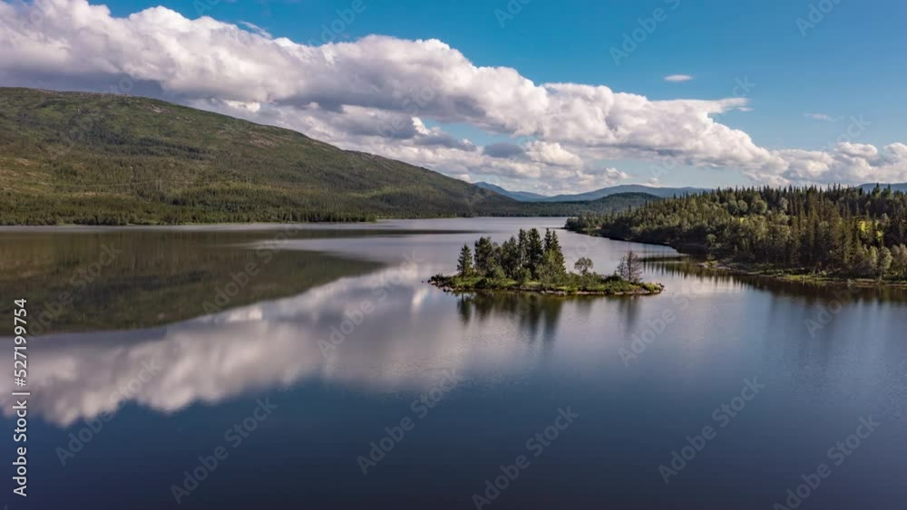 Lake with reflecting clouds and a small isle, in sunny Norway - aerial Hyperlapse Lake with reflecting clouds and a small isle, in sunny Norway - aerial Hyperlapse