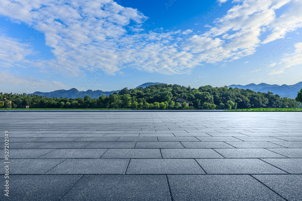 Empty square floor and green forest with mountain background Empty square floor and green forest with mountain background