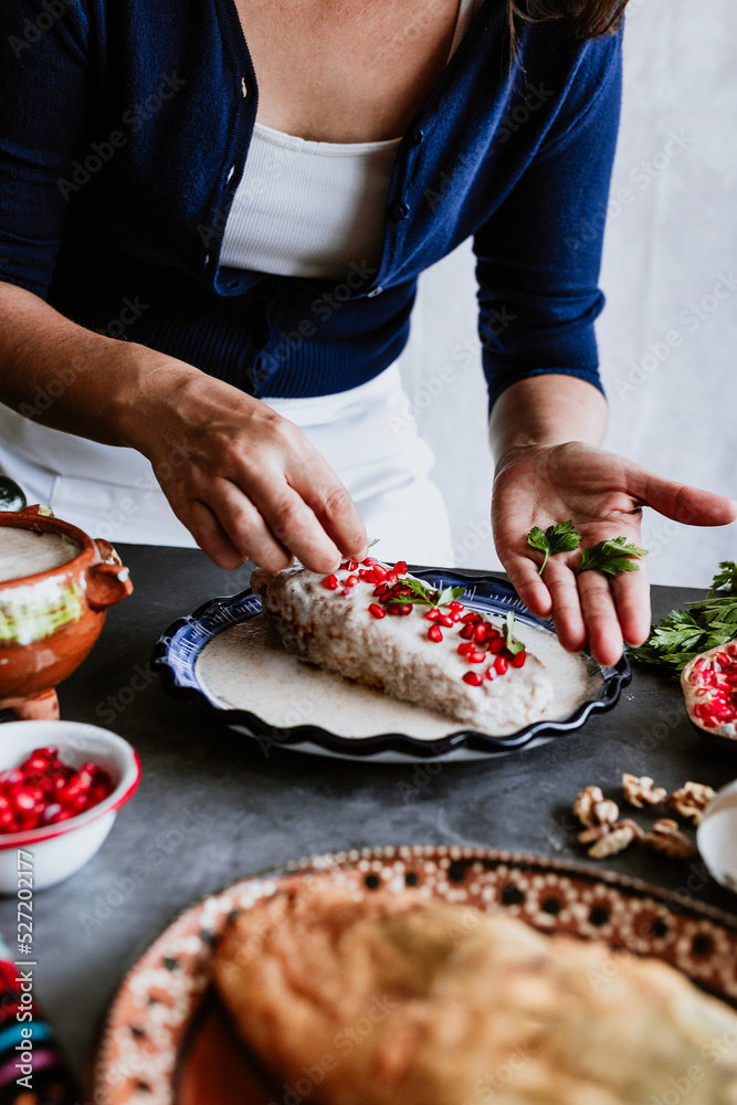 mexican woman hands preparing and cooking chiles en nogada recipe with Poblano chili and ingredients, traditional dish in Puebla Mexico	