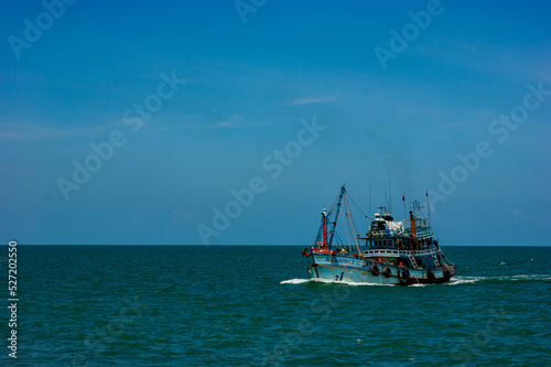 Fish boat vessel fishing in a rough sea.
