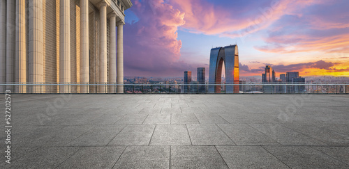 Fototapeta Empty floor and modern city skyline with building at sunset in Suzhou, China