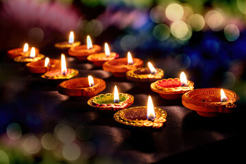 Diwali, Deepavali Hindu festival. Diya lamp lit on bokeh lights