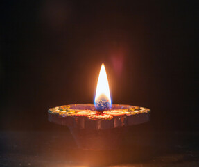 Diwali, Deepavali Hindu festival of lights. Diya lamp lit on black, close up