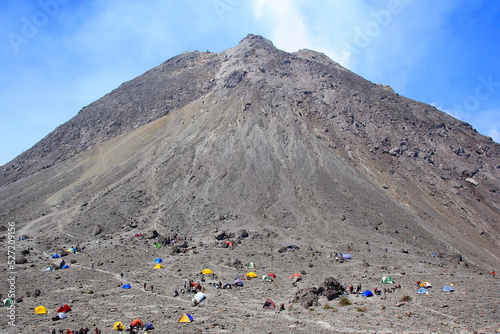 Boyolali, Indonesia, Oct 25, 2014. Climbers of Mount Merapi set up tents in the Pasar Bubrah area, the last camp boundary before continuing their journey to the top. photo