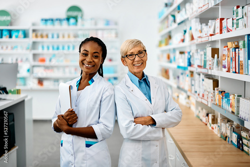 Portrait of happy female pharmacists in pharmacy looking at camera. photo