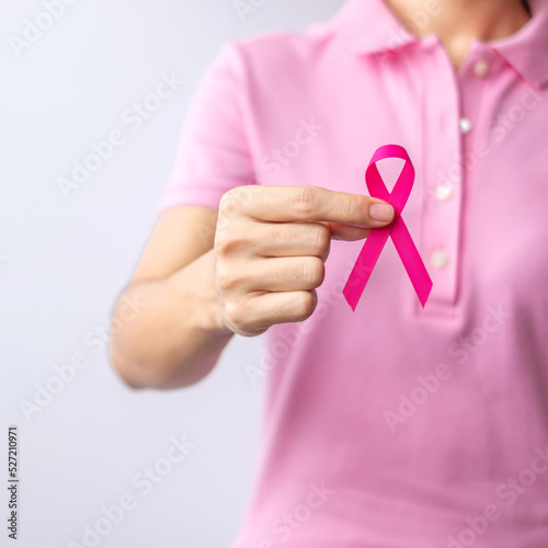 Pink October Breast Cancer Awareness month  woman hand hold pink Ribbon and wear shirt for support people life and illness. National cancer survivors month  Mother and World cancer day concept