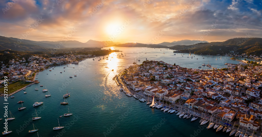 Fototapeta premium Aerial panorama of the city and harbor of Poros island in the Saronic Gulf, Greece, during a colorful summer sunset