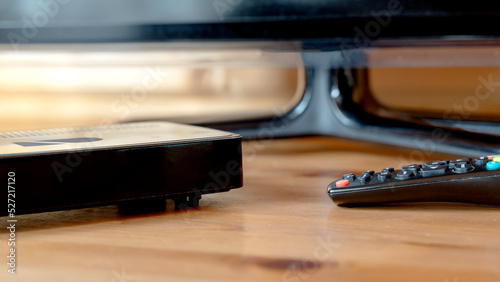 TV set-top box on a wooden background in