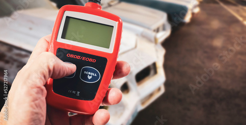 Mechanic holding code reader for vehicle photo